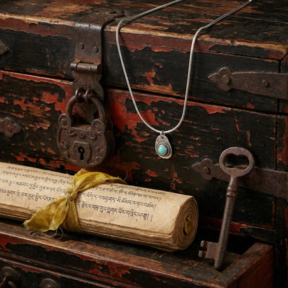 The Solar Amulet talisman displayed in a rustic chest with an old scroll, reflecting Himalayan heritage and protection.