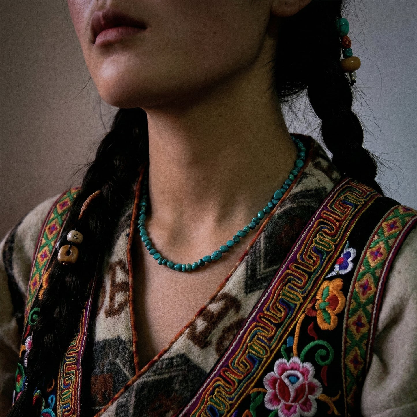 Side view of the Plateau Stream necklace on a model, highlighting its fluid drape and ethnic style.