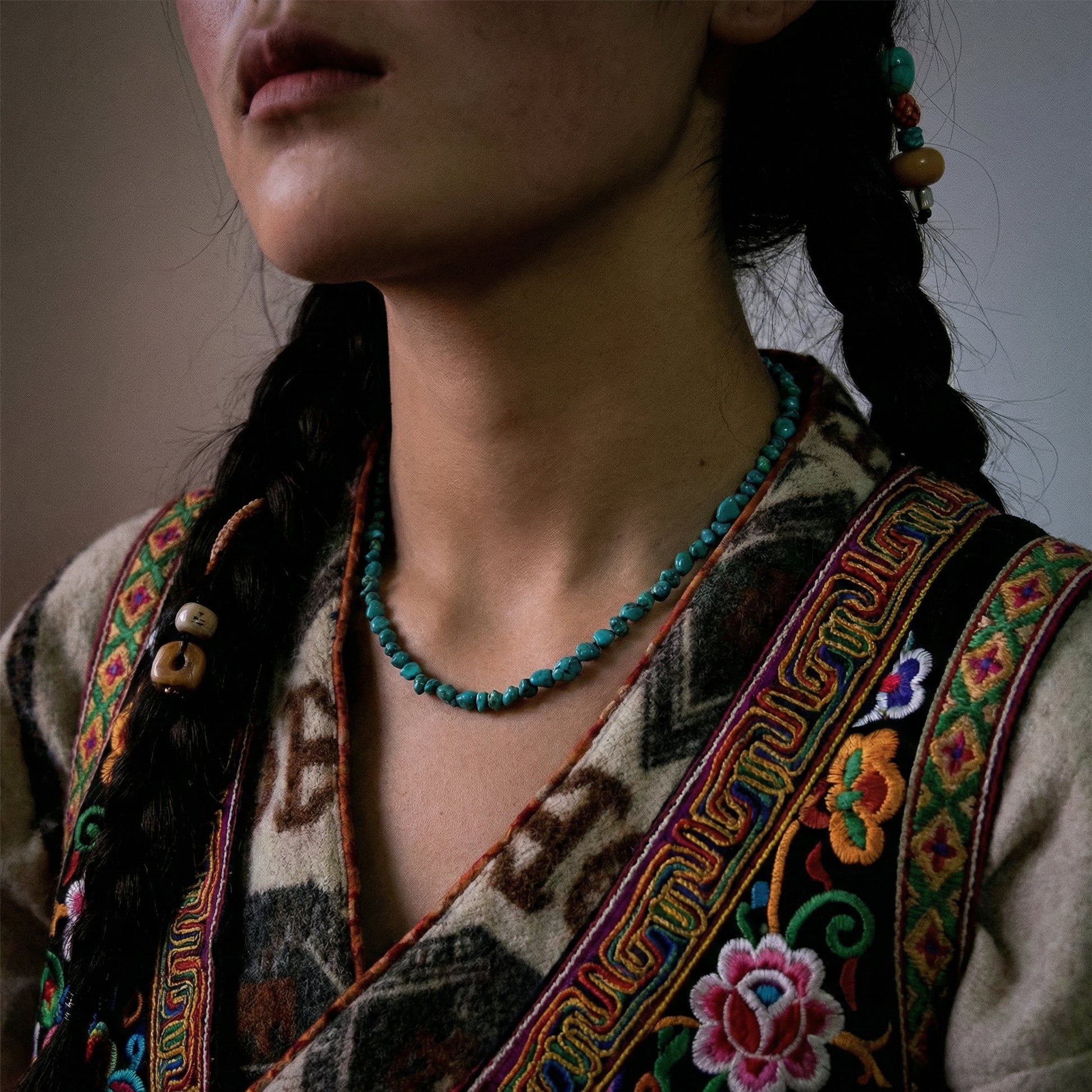 Side view of the Plateau Stream necklace on a model, highlighting its fluid drape and ethnic style.