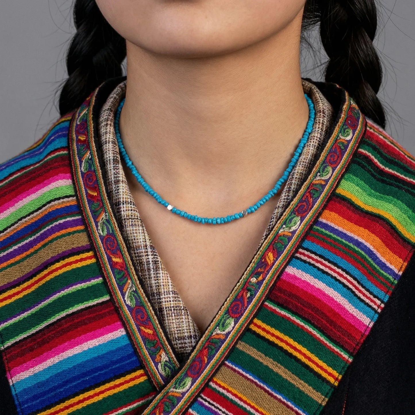 Front view of the Tibetan turquoise necklace on a model, showcasing its fluid drape and organic stones.