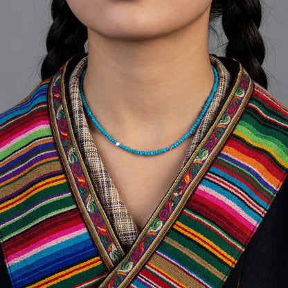 Front view of the Tibetan turquoise necklace on a model, showcasing its fluid drape and organic stones.