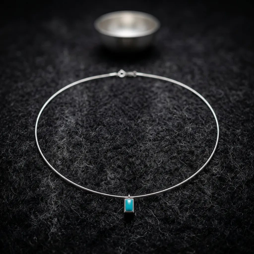 The Clarity Frame necklace displayed in a meditative setting with a silver bowl, reflecting Himalayan heritage.