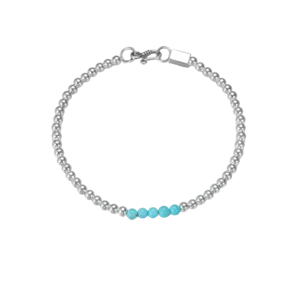 Angled view of the silver bead bracelet on a white background, showing the luster of the high-porcelain turquoise.