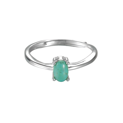 Top view of the Stillness turquoise ring on white background, showcasing stone clarity and silver polish.