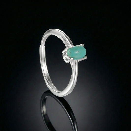 The Stillness Ring featuring a horizontal oval Tibetan turquoise in a 925 silver four-prong setting.