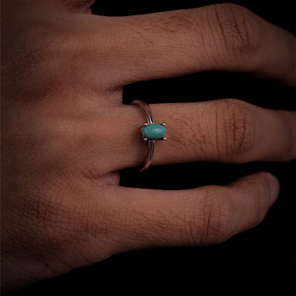 A model wearing the Stillness ring, showcasing the elegant east-west horizontal stone orientation.