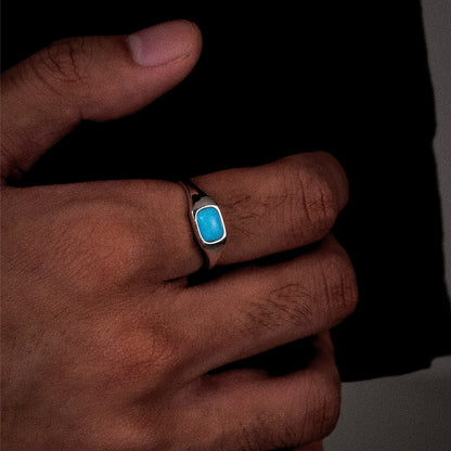 Close-up of a model wearing the Stillwater signet ring, showcasing its weighted and modern profile.
