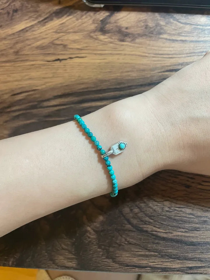 Customer wearing a turquoise bead bracelet with sterling silver detail