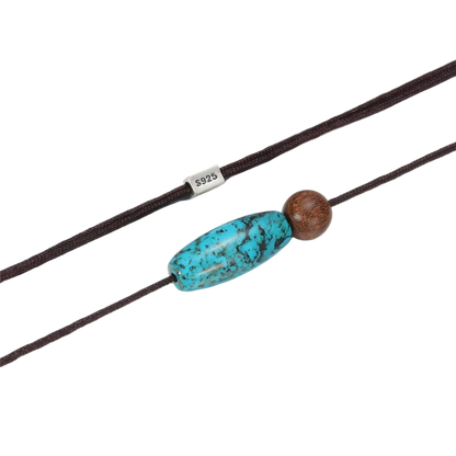 Close-up of the natural matrix in the barrel-cut turquoise and the discrete 925 sterling silver clasp.