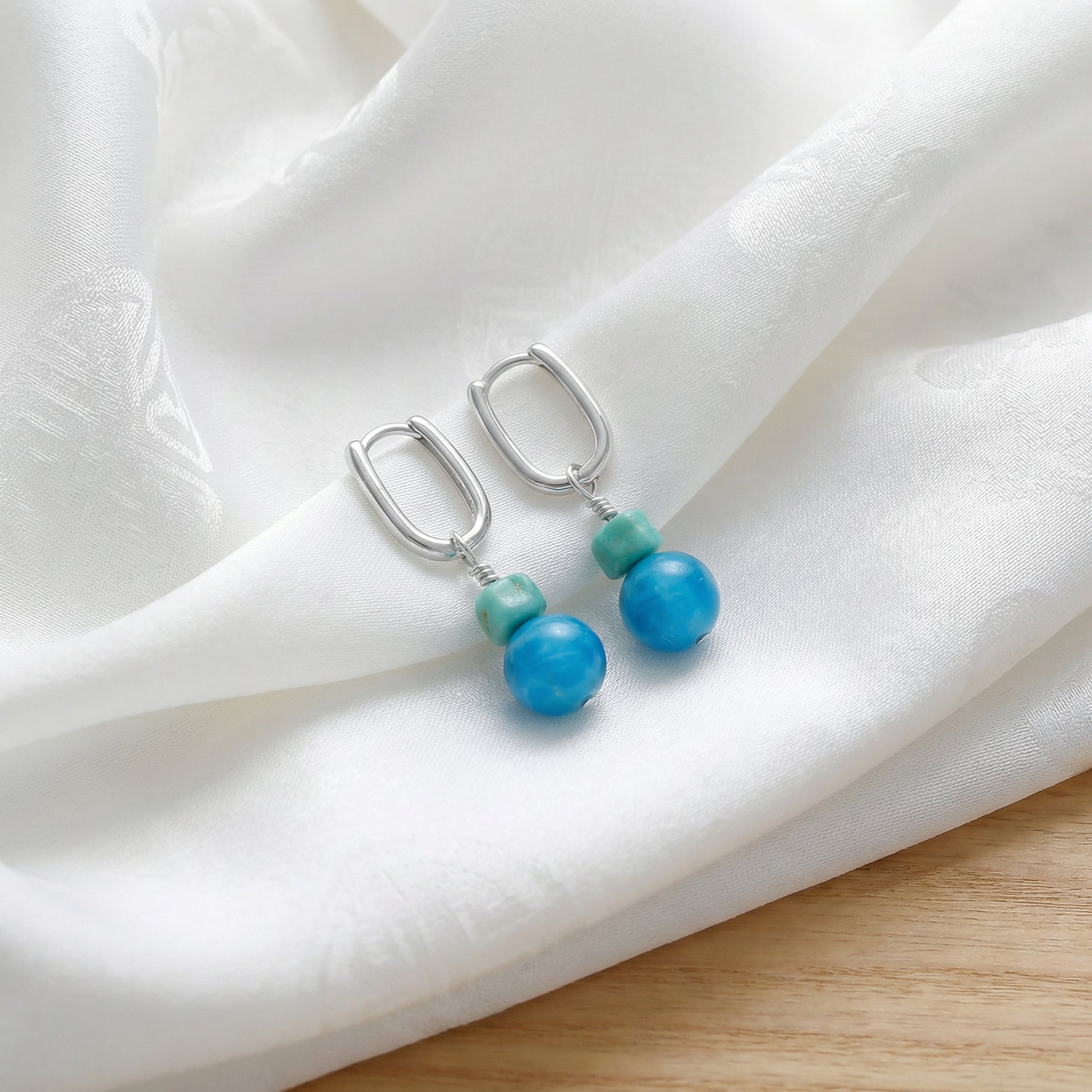 The Serene Drops displayed on soft white silk, reflecting purity, calm, and Himalayan heritage.