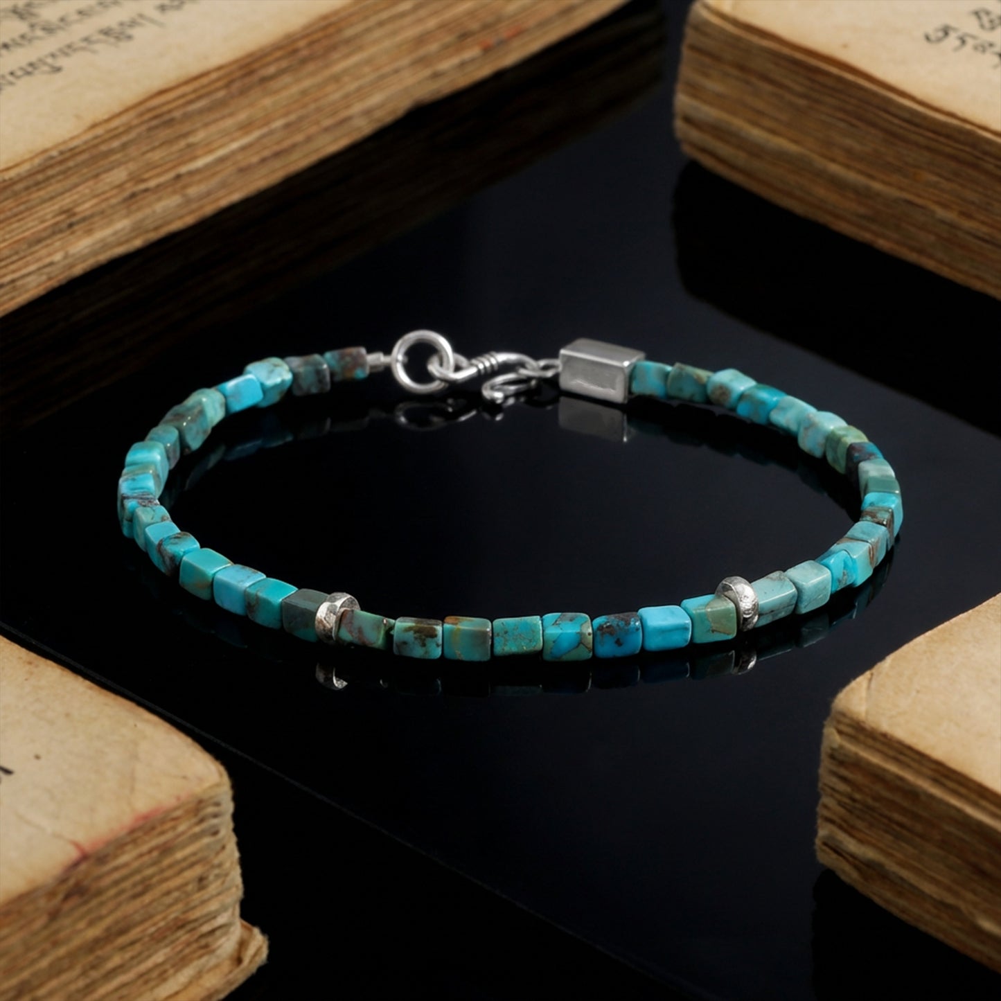 The Clarity Bracelet displayed on ancient weathered books, symbolizing wisdom and Himalayan heritage.