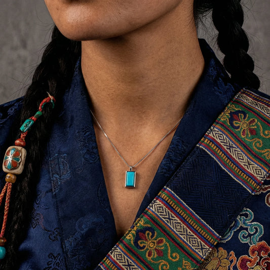 Close-up of a model wearing the rectangular turquoise frame necklace for mental focus and style.