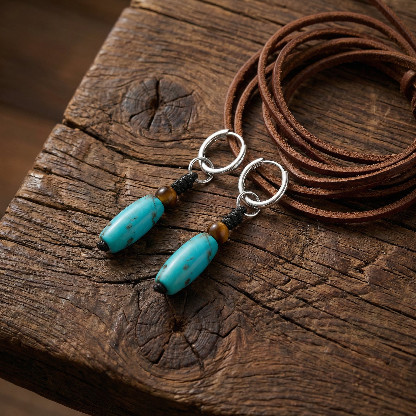 The Knot Drops displayed on rustic weathered wood with a leather cord, reflecting Himalayan heritage and grounding energy.