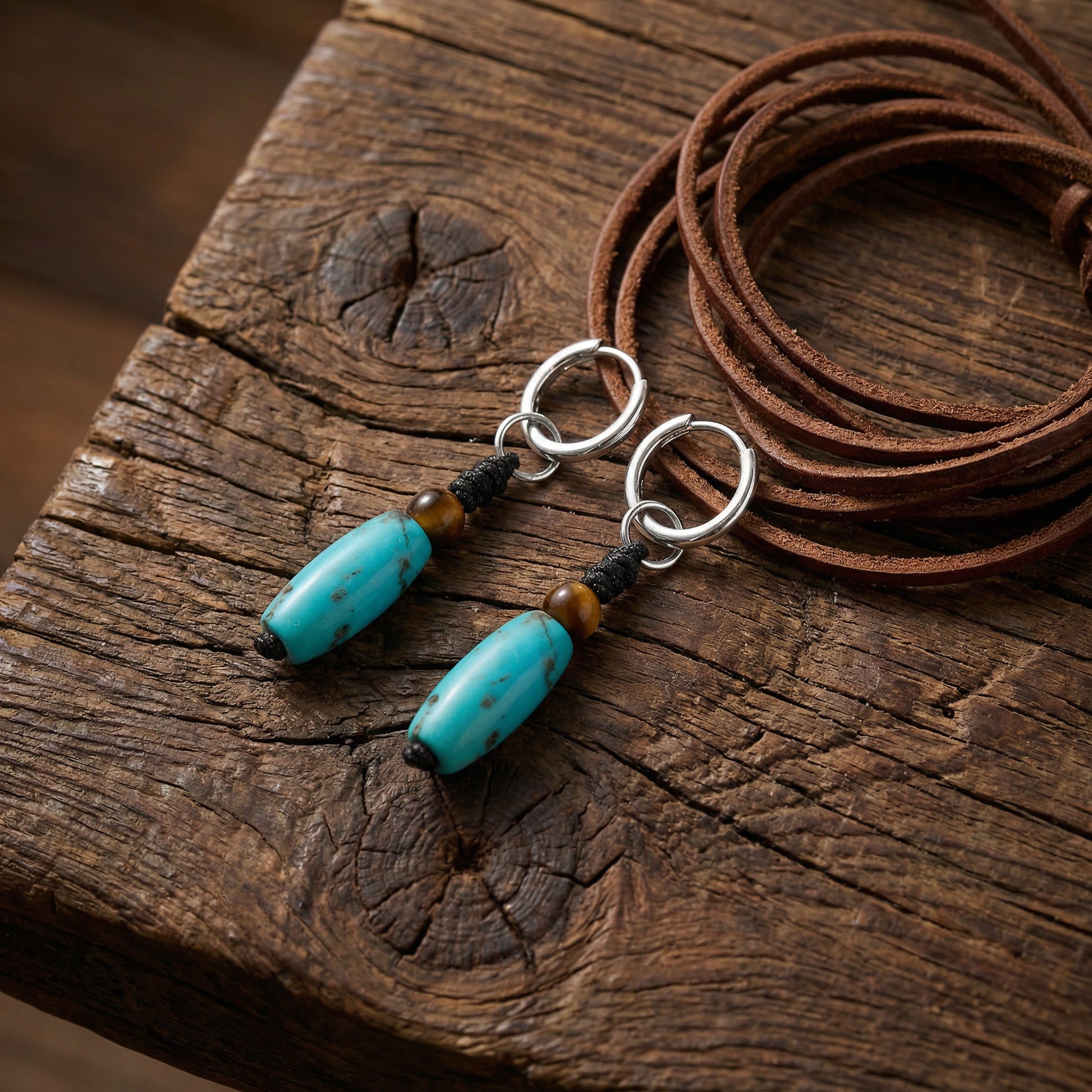 The Knot Drops displayed on rustic weathered wood with a leather cord, reflecting Himalayan heritage and grounding energy.